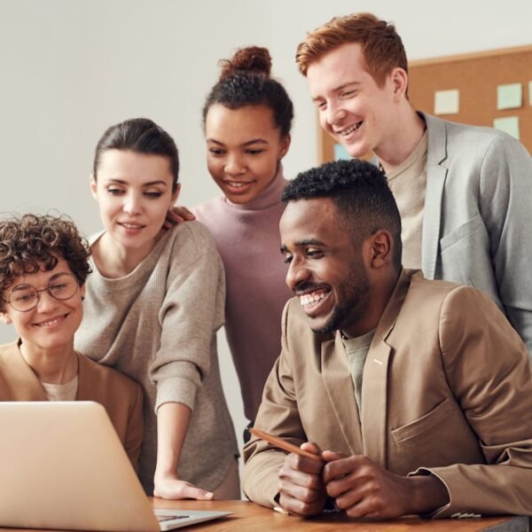 Small business sales team reviewing inbound leads on laptops in a modern office, illustrating the qualification and routing process