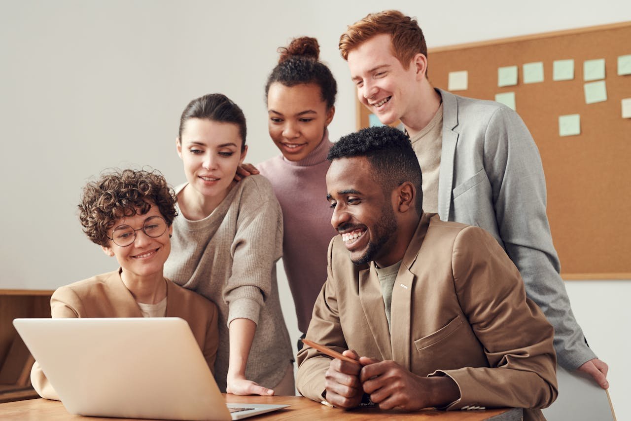 Small business sales team reviewing inbound leads on laptops in a modern office, illustrating the qualification and routing process