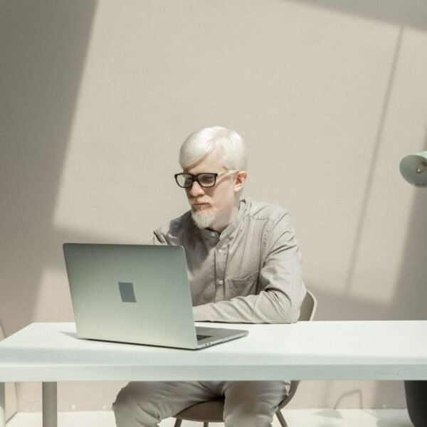 A small business owner reviewing a customer pipeline on a laptop in the office