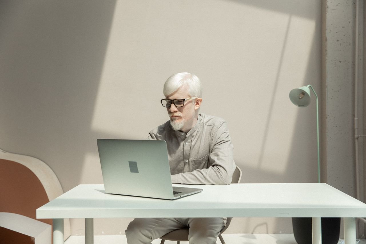 A small business owner reviewing a customer pipeline on a laptop in the office